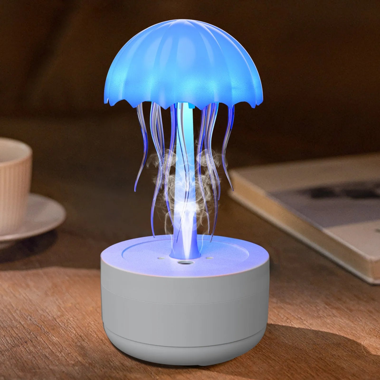 White jellyfish-shaped humidifier and essential oil diffuser with colourful night light on wooden desk