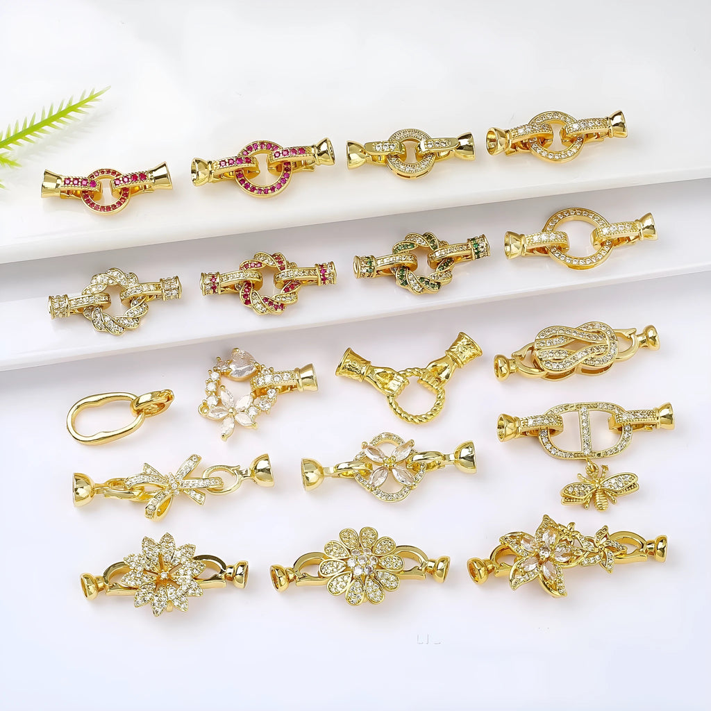 Small gold-colour metal jewellery clasp with a white pearl detail on the buckle
