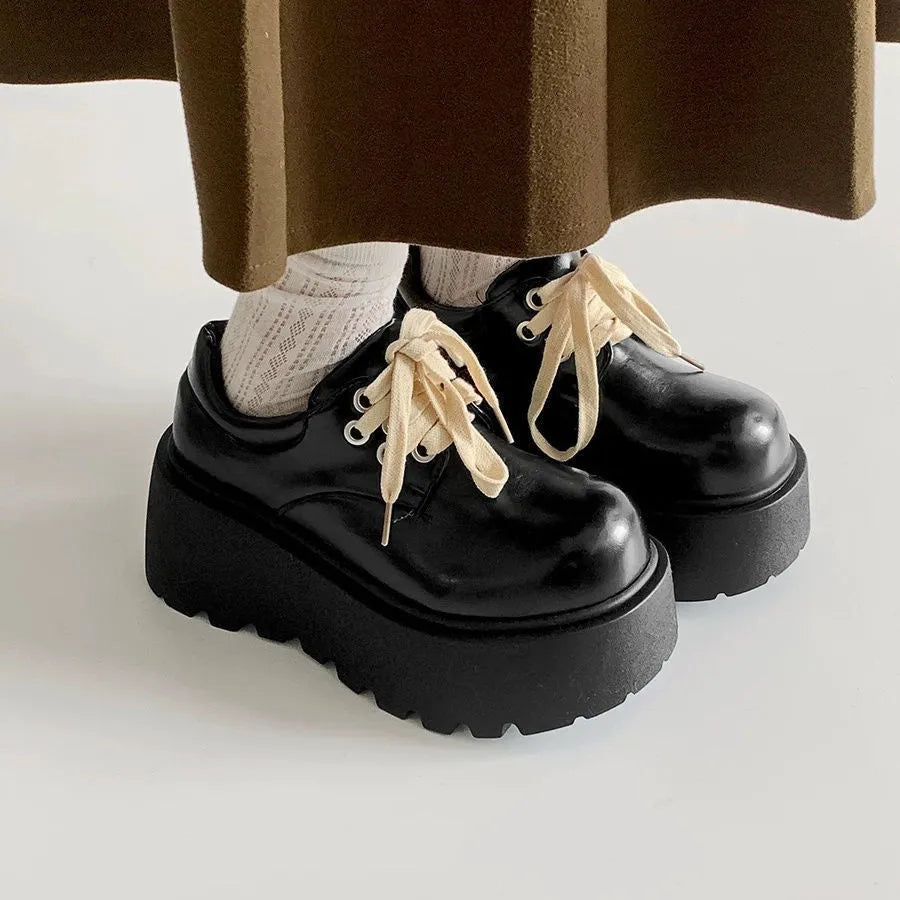 Matte black women's lace-up ankle boots with a chunky 6-8 cm heel and thick rubber sole.