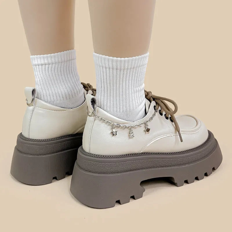 British style white platform leather Mary Jane shoes with chunky heel and lace-up front.