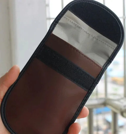 Black microfiber Faraday cage pouch for blocking car key and RFID signals.