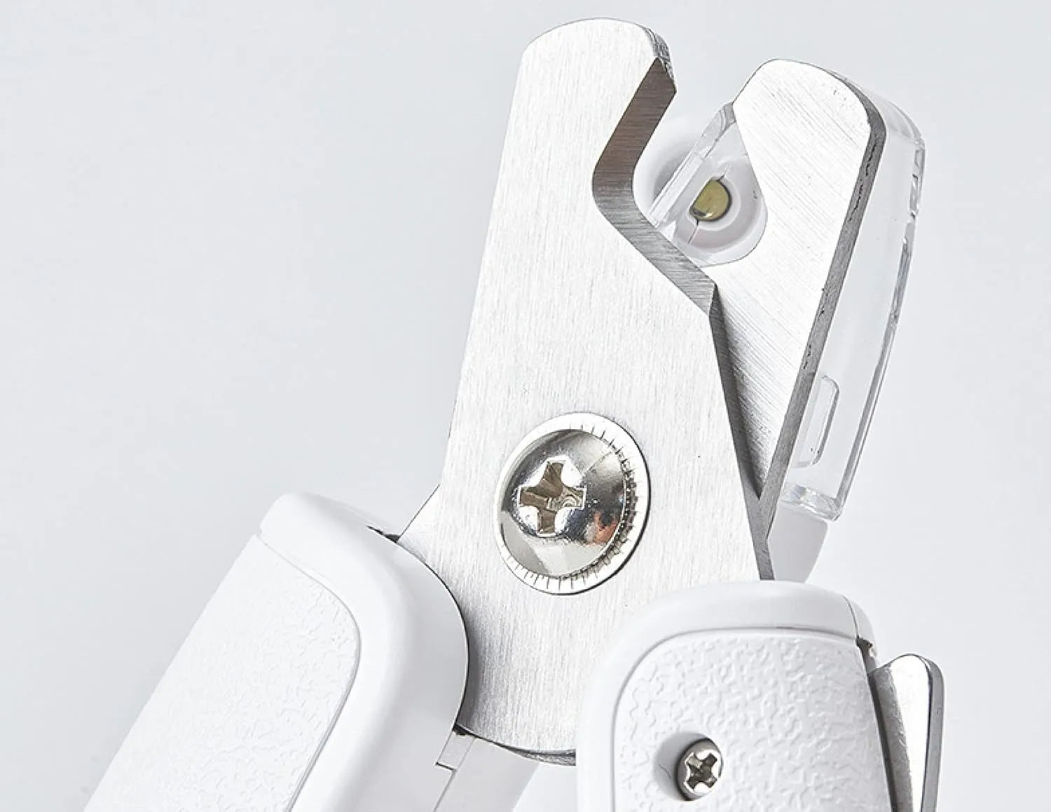 White pet nail clippers with LED light, transparent anti-splash guard, and integrated nail file on a grey background.