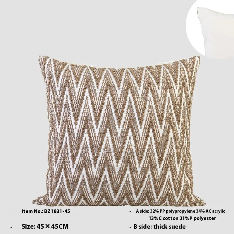 Square Chinese style cushion with geometric pattern in brown Maillard colour options on a sofa.