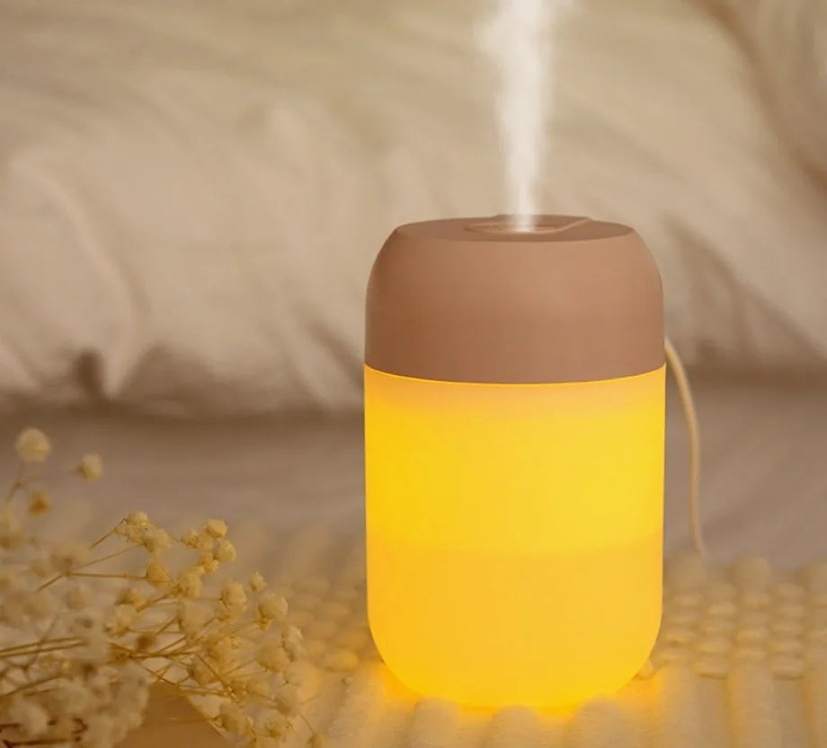 White cylindrical USB-powered mini humidifier with charging cable