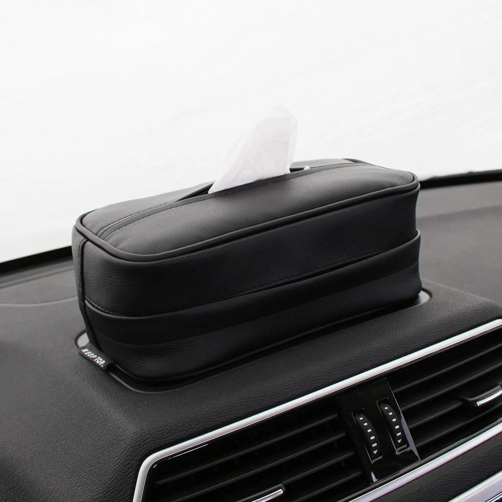 Black PU leather car storage box with hanging straps shown on a car headrest.