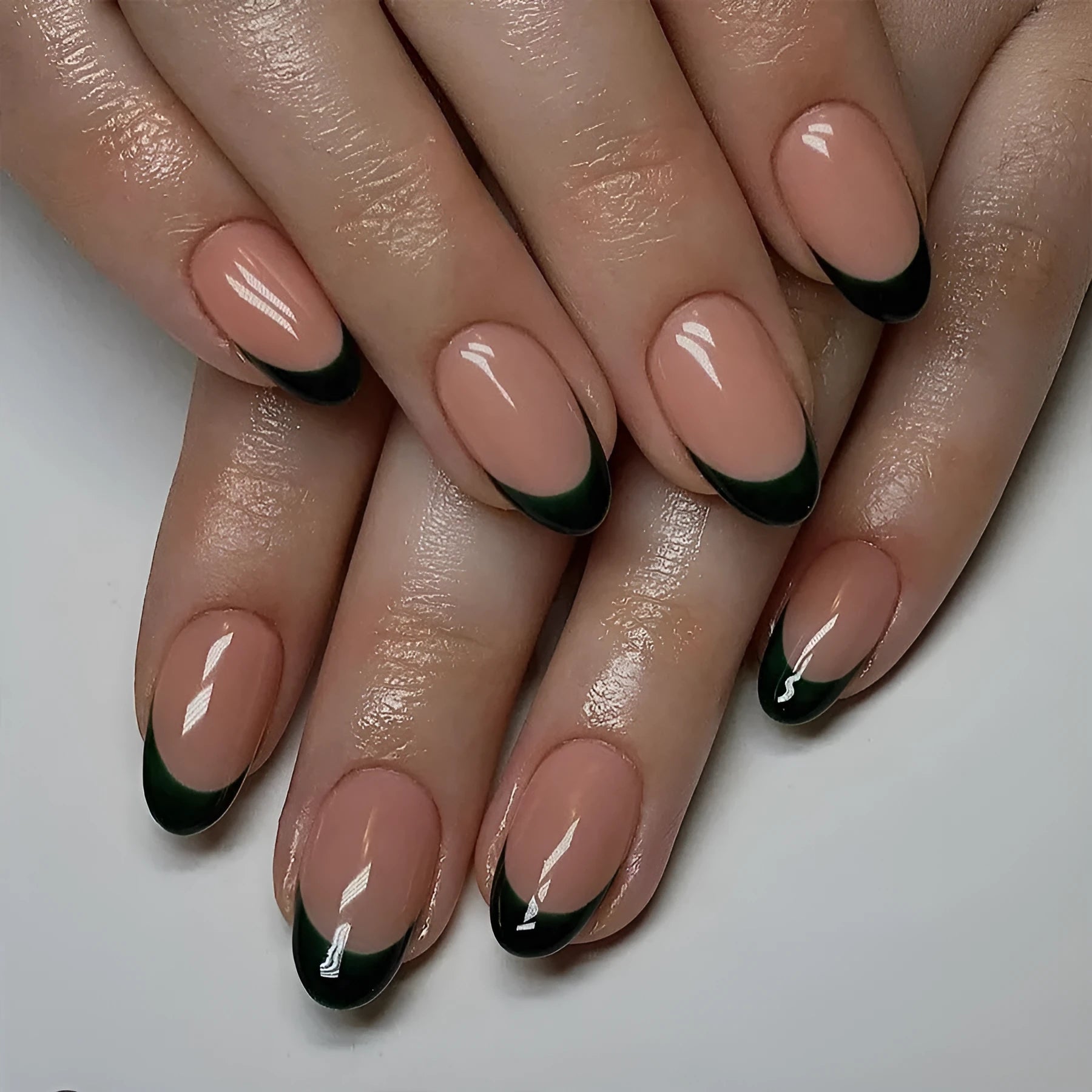 24 artificial press-on nails showing short almond shape with matte black French manicure design