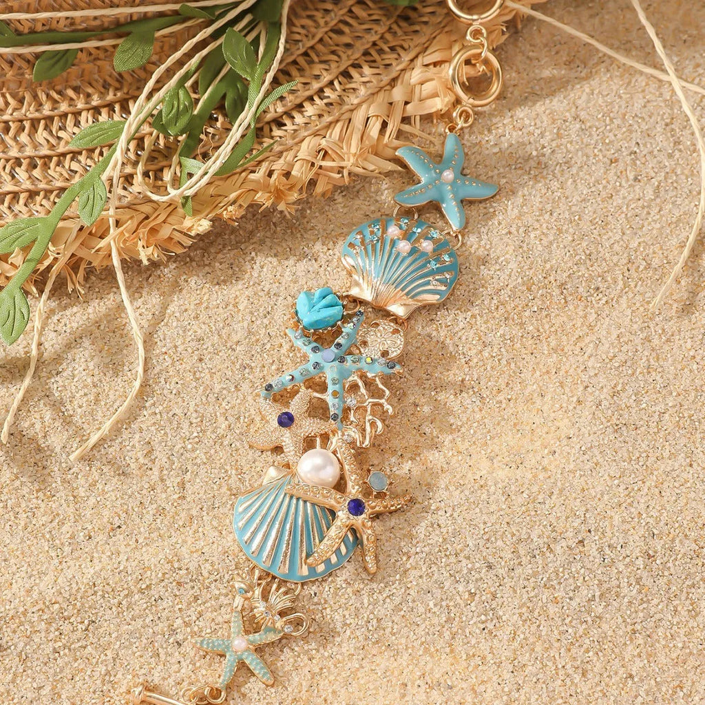 Women's alloy bracelet with marine shell, boat anchor, and starfish design in blue, red, or turquoise.