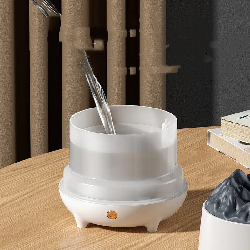 White volcanic-shaped ultrasonic humidifier and essential oil diffuser with USB cable on a wooden table.