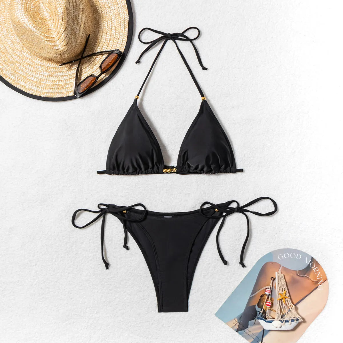 Black women's polyester bikini swimsuit with metal bead detail and split design