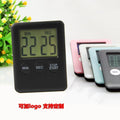 Black and white kitchen timer with magnetic back showing count-up and countdown functions