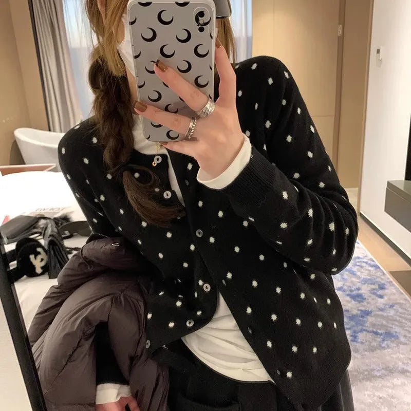 Women's grey dot knitted cardigan with crocheted flower details on sleeves, loose fit.