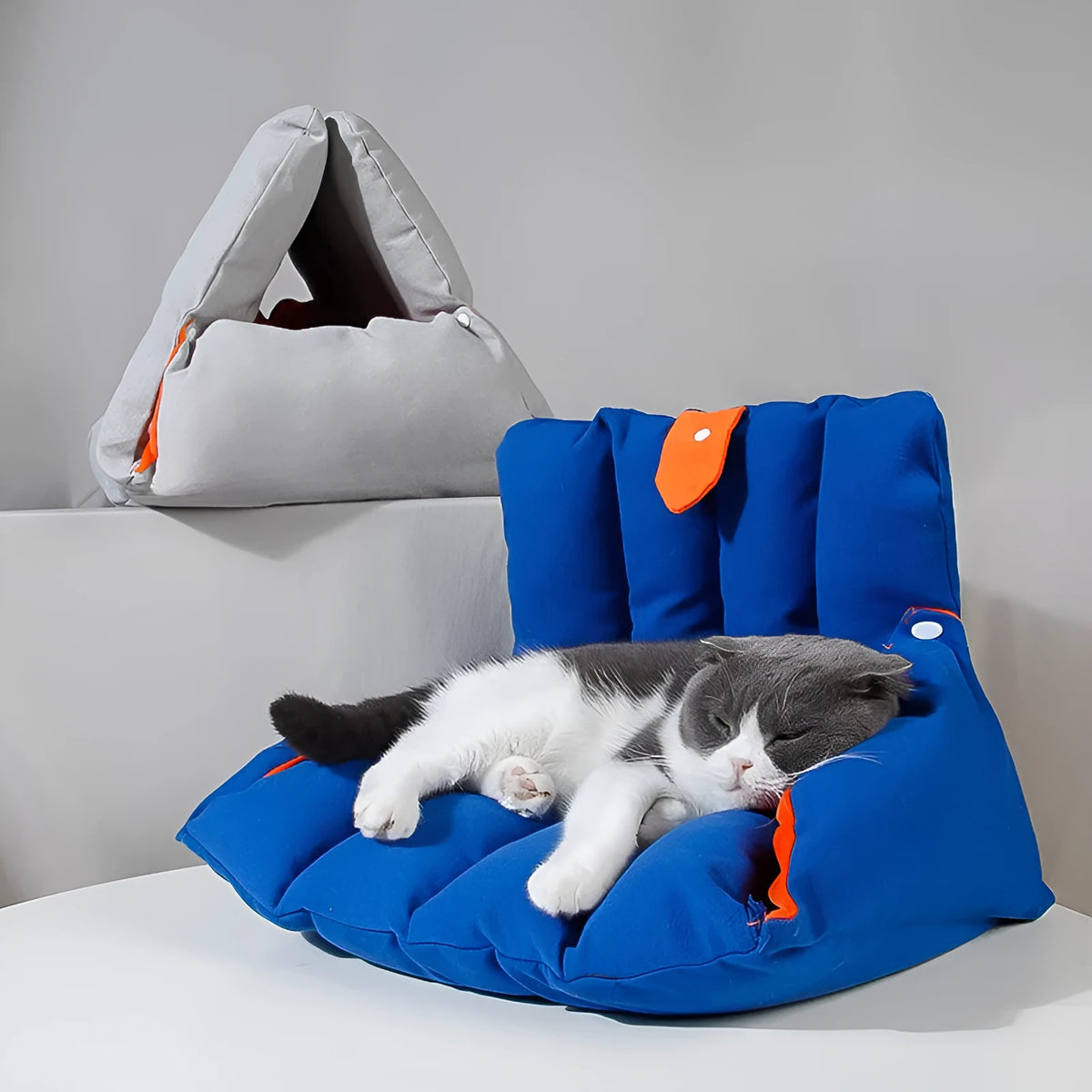 Blue triangular fabric cat nest with visible holes for connection, shown with removable cotton cover.