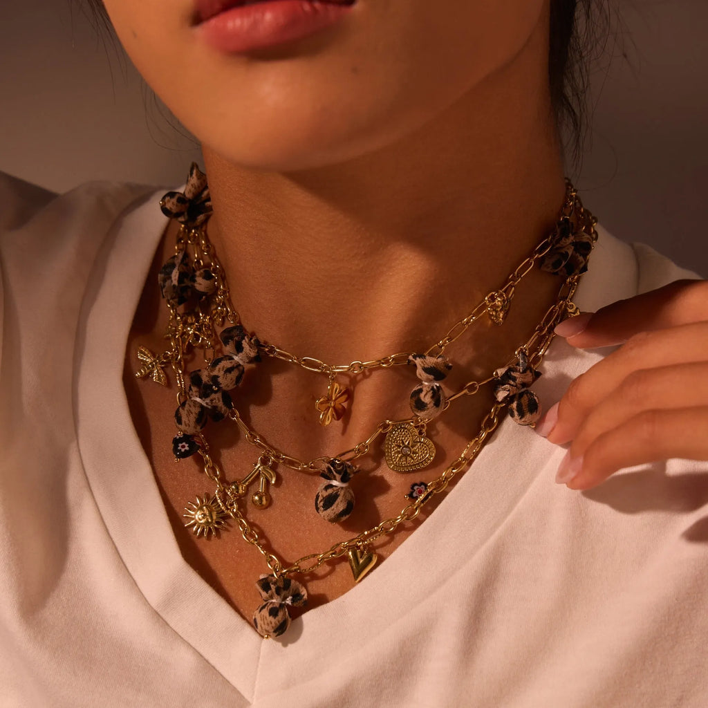 Geometric pendant stainless steel necklace with leopard, love heart and flower designs on adjustable chain