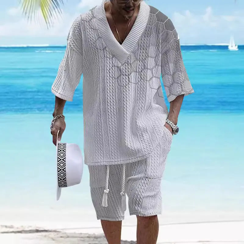 Man wearing a printed drop-shoulder knitted short-sleeve top with matching shorts in a casual setting.