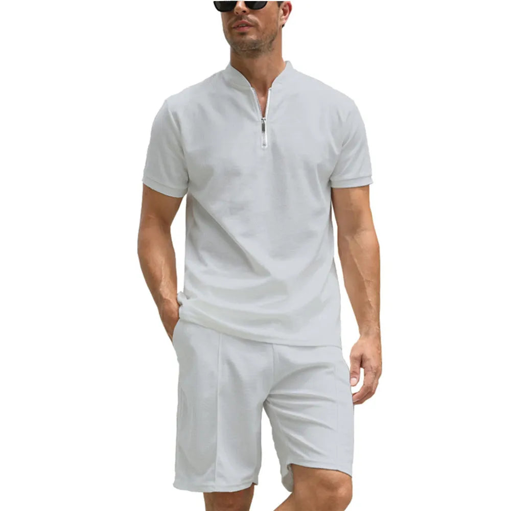 Men's solid colour polo shirt and matching trousers two-piece set on a hanger.