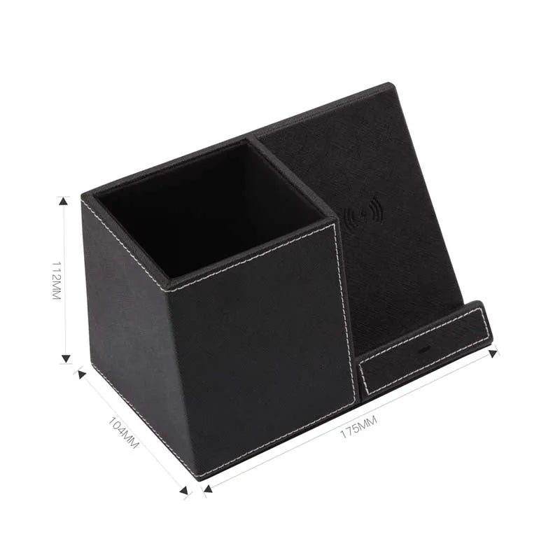 Black leather wireless charging station with built-in pen holder on a wooden desk.