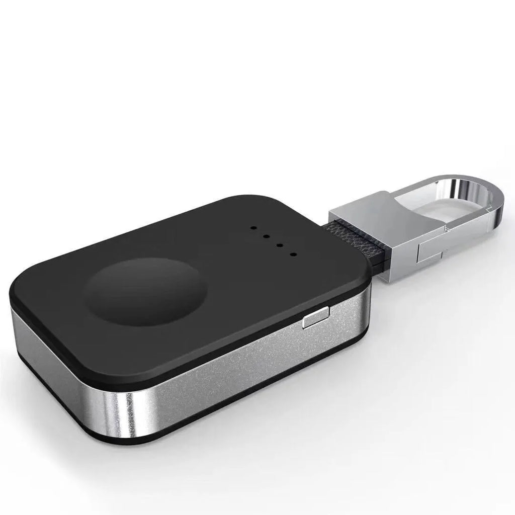 Black Apple Watch portable wireless power bank with keychain ring, shown next to an Apple Watch.