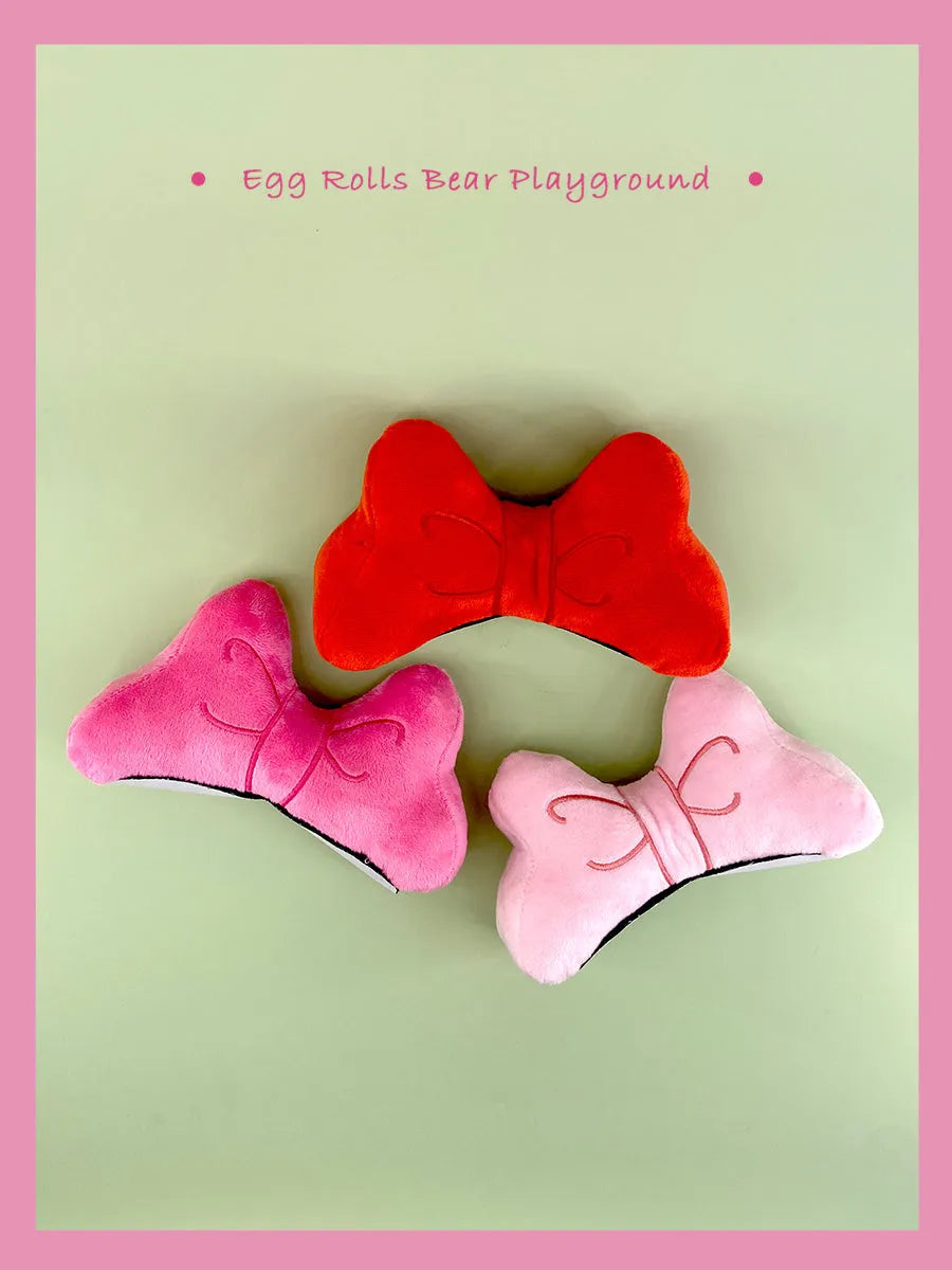 Soft plush bow decoration for motorcycle or ski helmet in red, peach pink, and rose pink colour options.