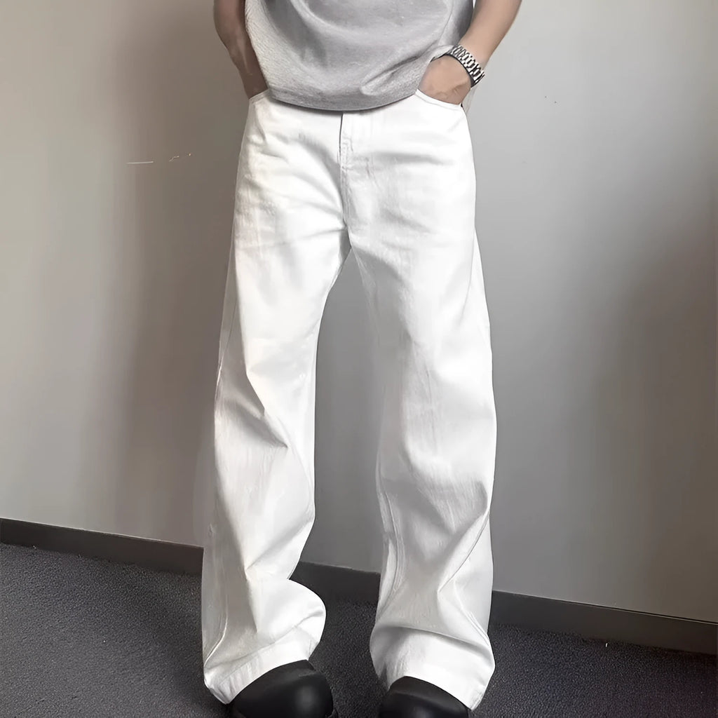 Men's white loose fit straight leg denim jeans on a mid waist with a zipper fly.