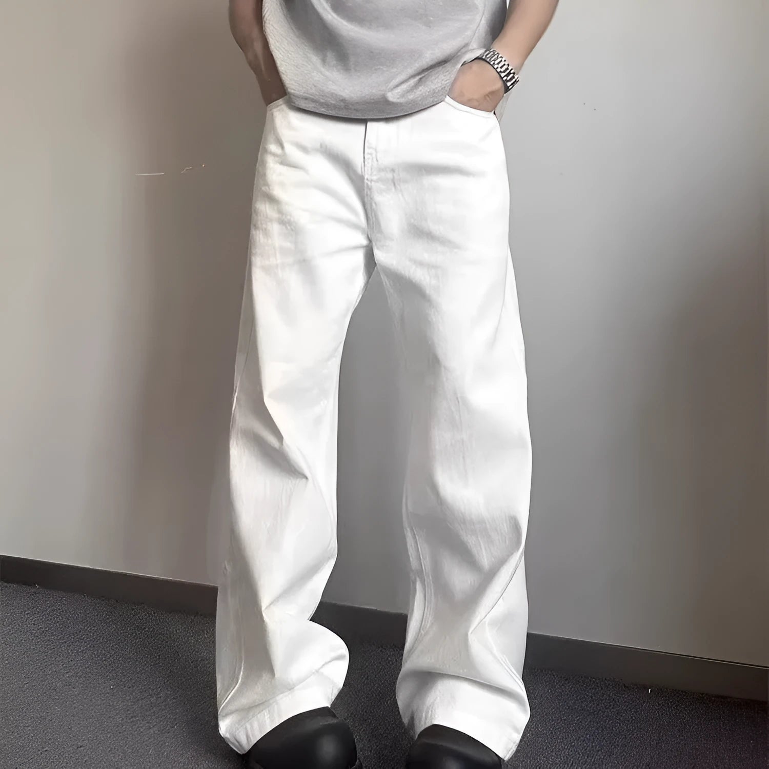 Men's white loose fit straight leg denim jeans on a mid waist with a zipper fly.