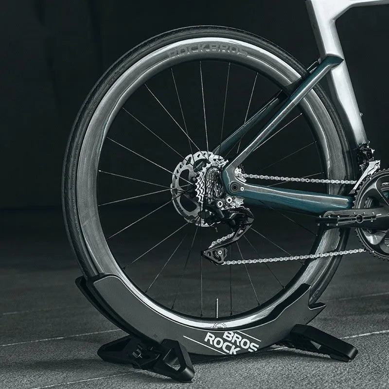 Black ABS plastic wall-mounted bike parking rack holder for road and mountain bicycles.