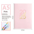 A5 daily planner with soft faux leather cover showing thread binding and open pages