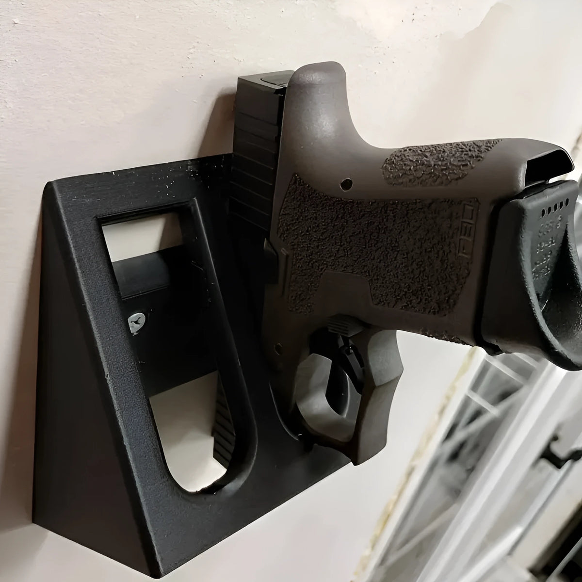 Black plastic pistol stand with punk-style design for displaying model firearms