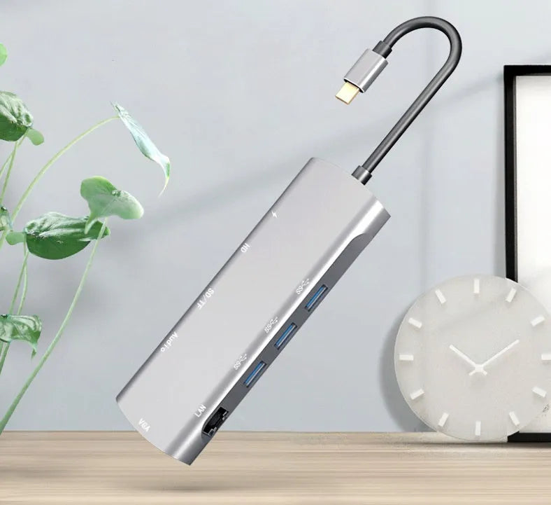 Grey aluminium USB-C docking station with HDMI, VGA, USB ports, and a 140mm cable.