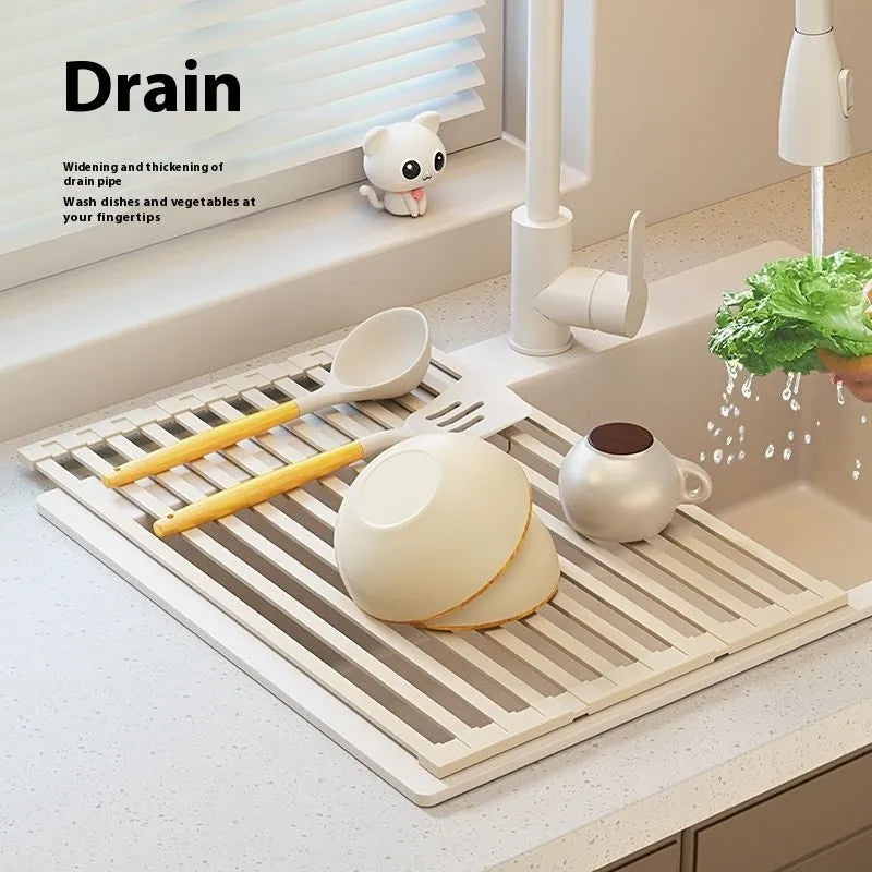 Foldable milky white stainless steel kitchen draining rack beside a sink
