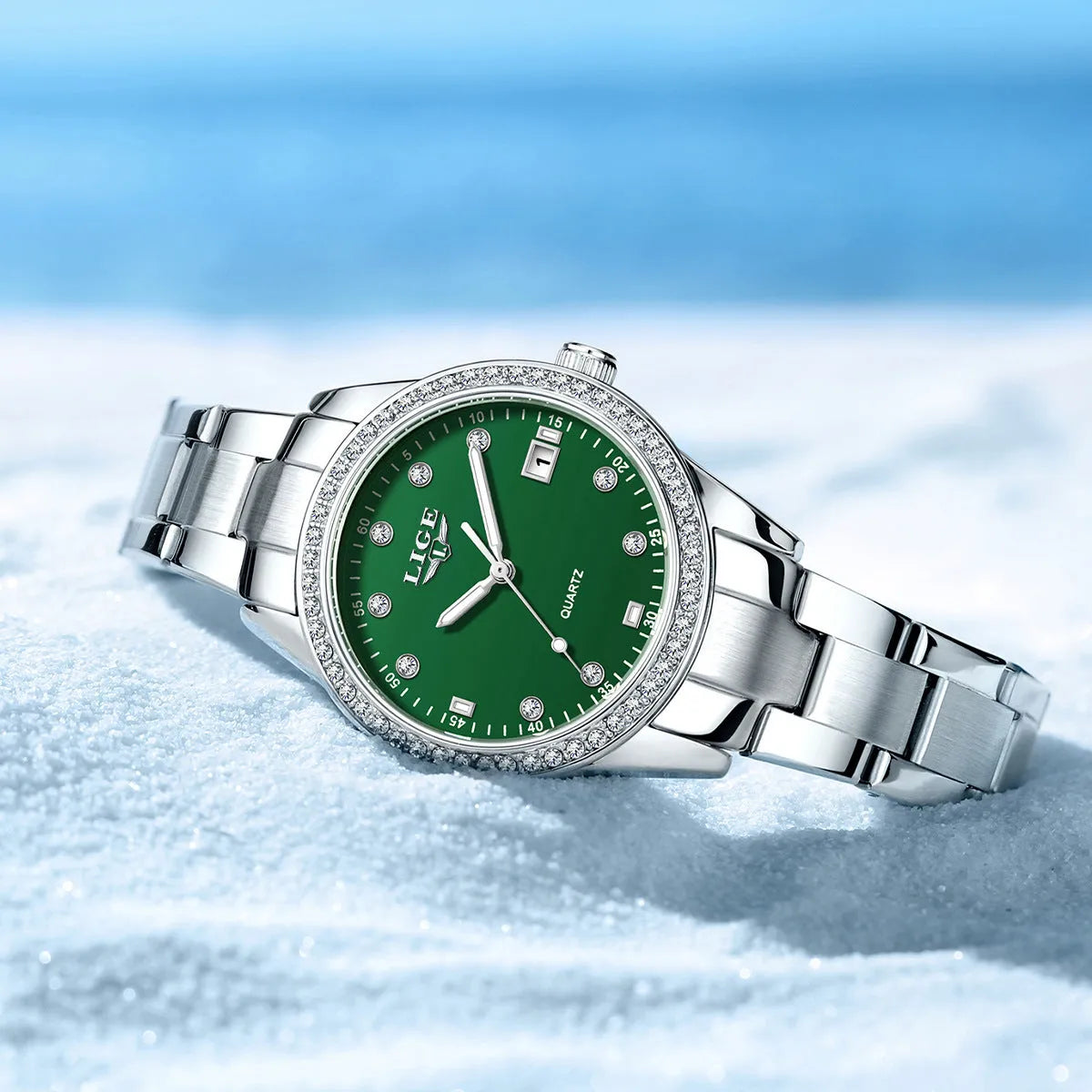 Silver stainless steel women's quartz watch with diamond bezel and luminous hands on a round 34mm dial.