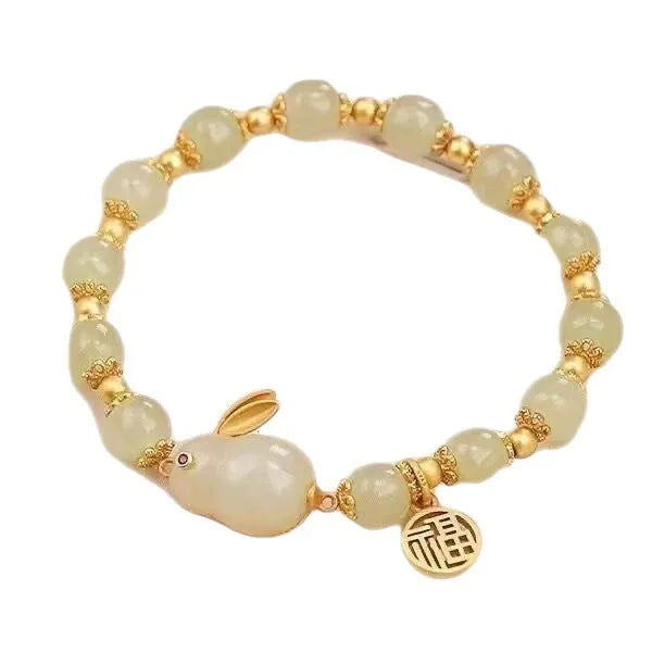 Green jade hare bracelet with black base, fu character design, and lily decorative elements