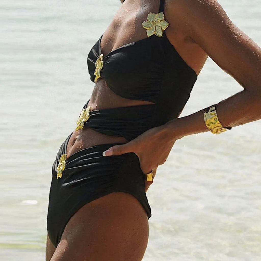 Women's solid colour one-piece swimsuit with hollow-out tube top and matching short skirt.