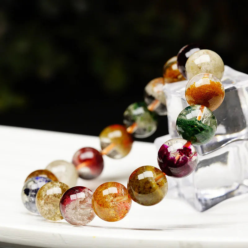 Natural crystal bracelet with 10mm beads showing ghost cornucopia ethnic design