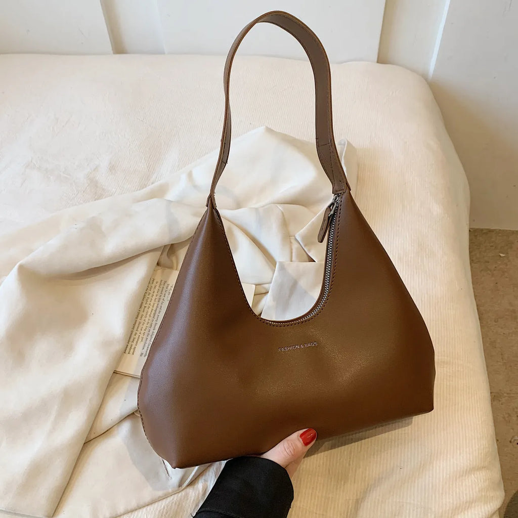 PU leather retro shoulder handbag in pillow design with single strap and internal organisation pockets