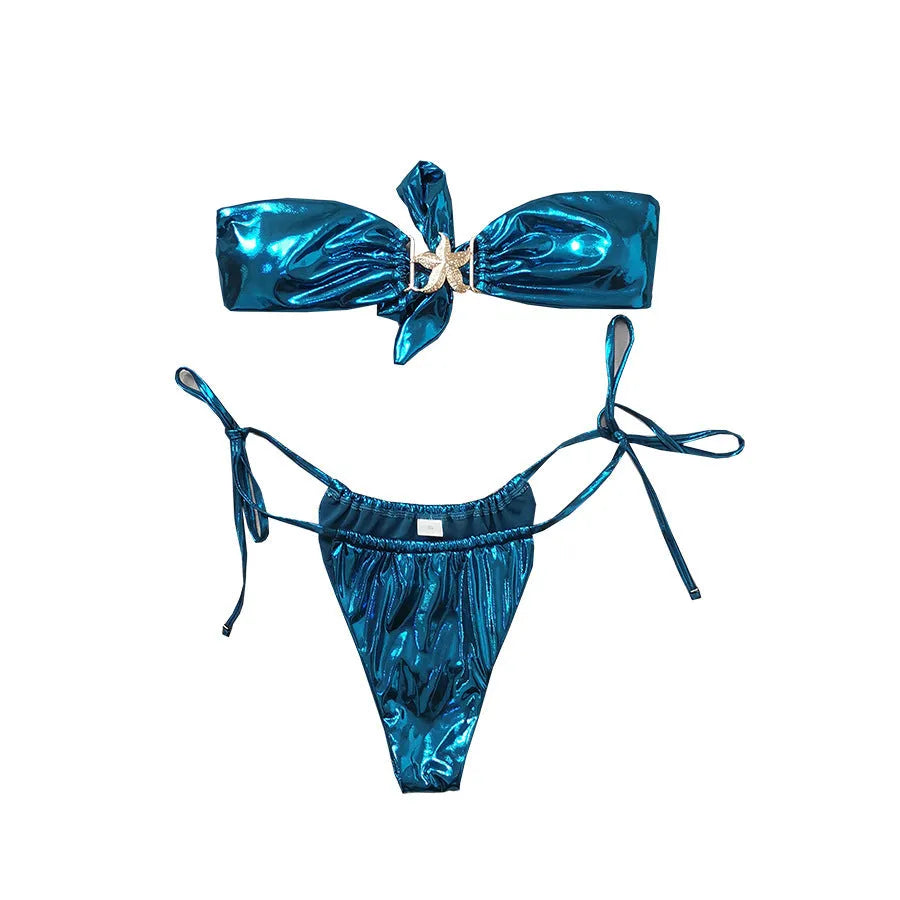 Glossy blue women's tube top bikini with gold starfish print on a beach.