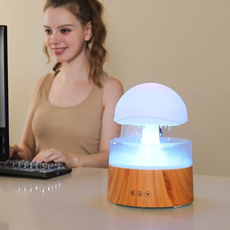 White cloud-shaped humidifier and aroma diffuser with coloured lights and simulated raindrops