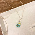 Women's necklace with a coloured glaze joker skirt pendant on a cotton and linen clavicle chain.