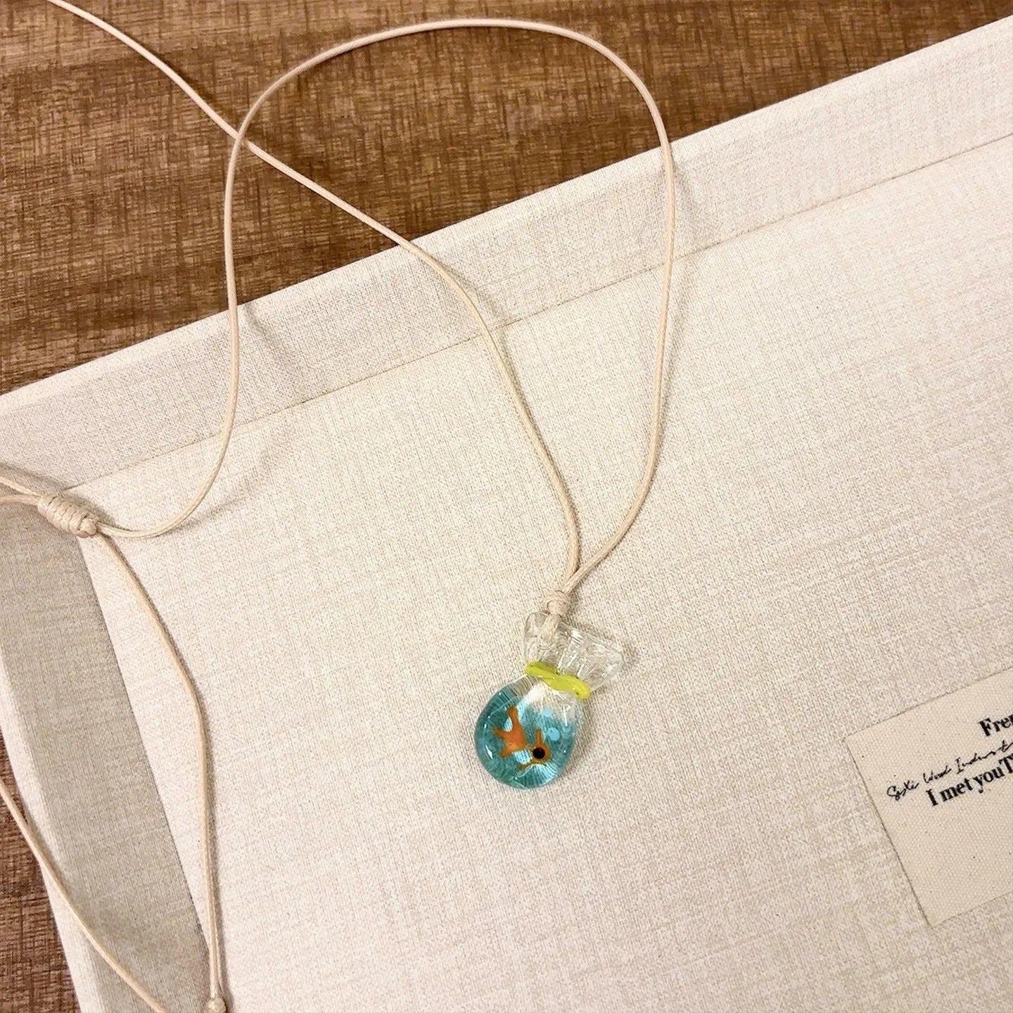 Women's necklace with a coloured glaze joker skirt pendant on a cotton and linen clavicle chain.