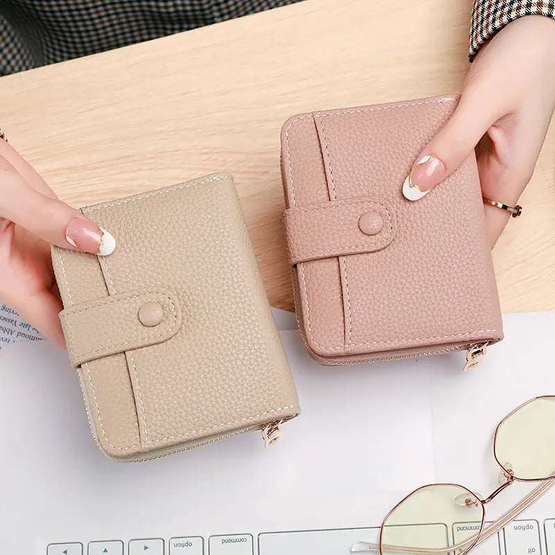 Short ladies wallet with lychee pattern in PU leather showing card slots and 2-fold construction