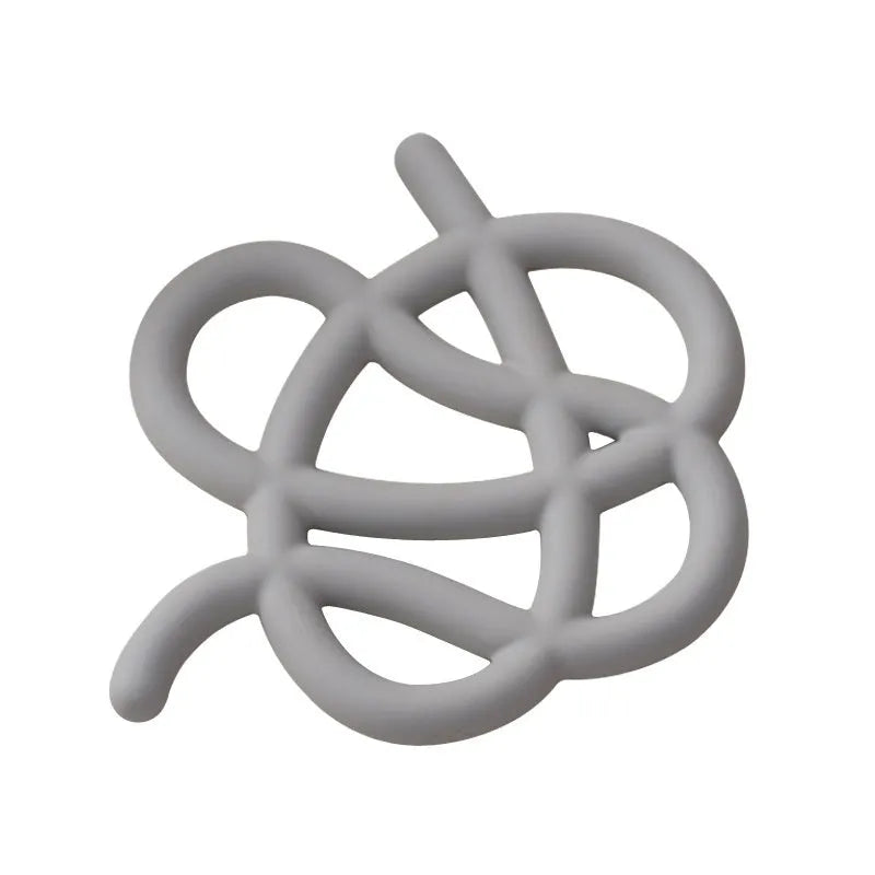 Ceramic heat proof mat in an irregular shape on a wooden table.