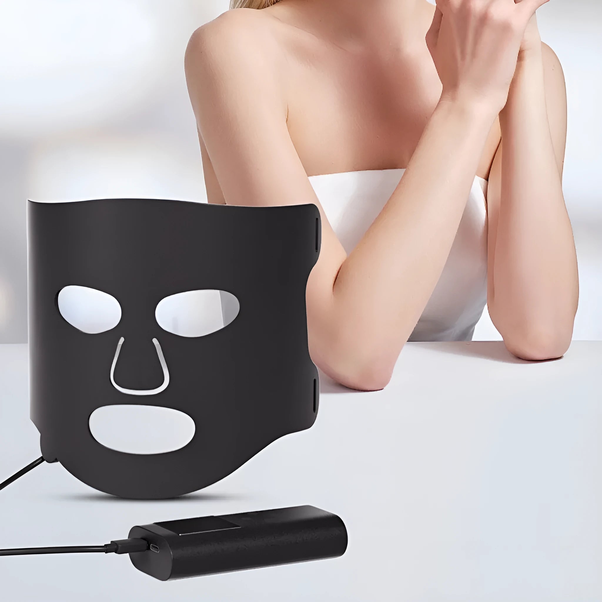 Black and white LED phototherapy face mask with controller for home skincare light therapy treatment