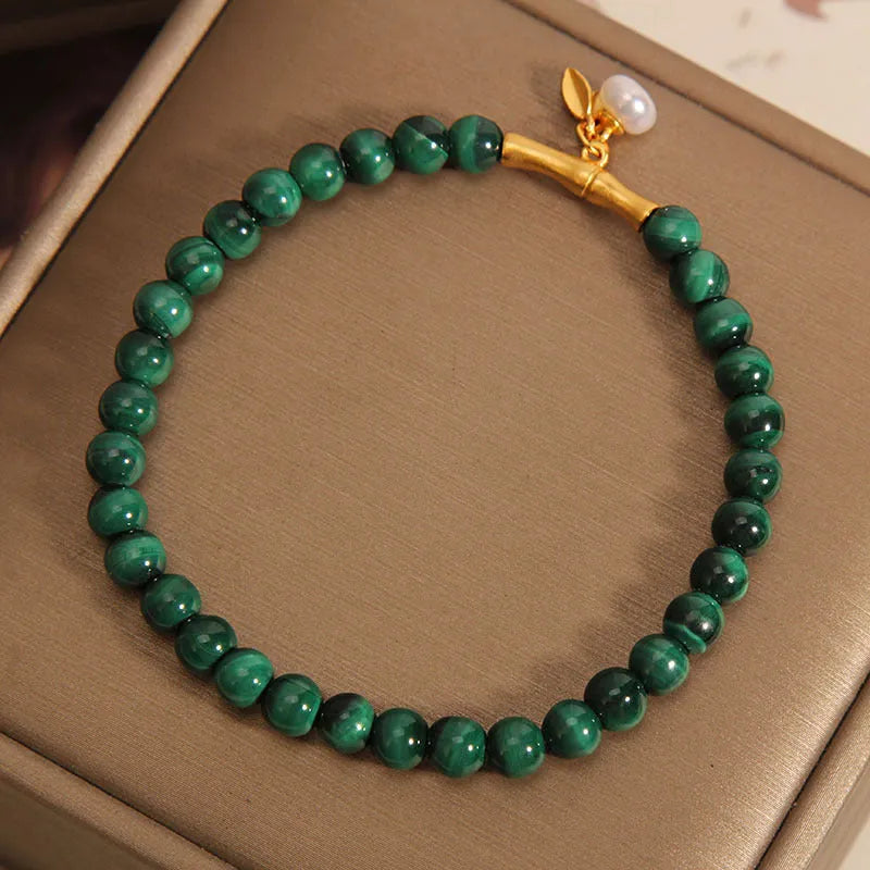Close-up of a women's adjustable crystal bracelet with a white Lucky Bamboo design on wrist.