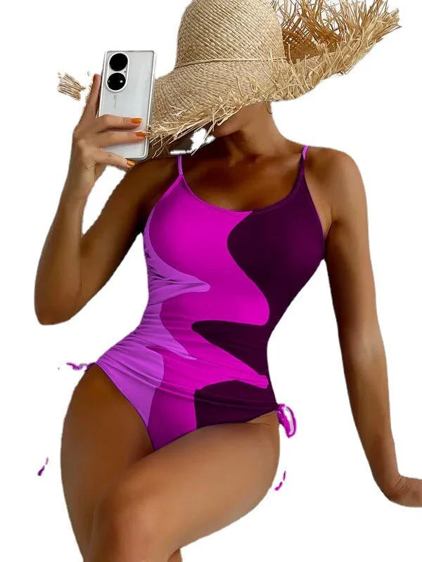 Women's sleeveless backless one-piece swimsuit in blue, purple, brown, or green with solid or striped pattern