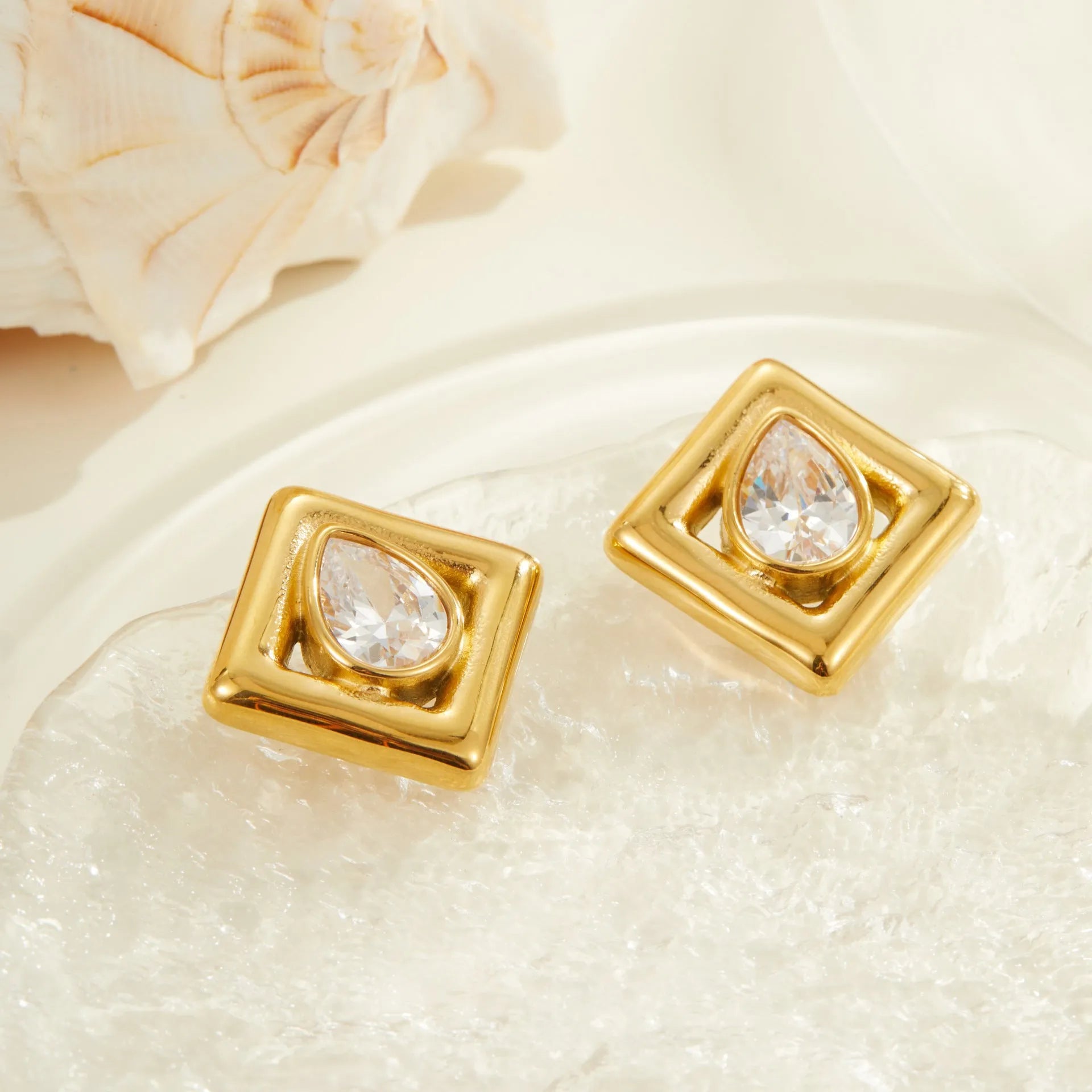 Gold electroplated stainless steel stud earrings with geometric water drop zircon inlay