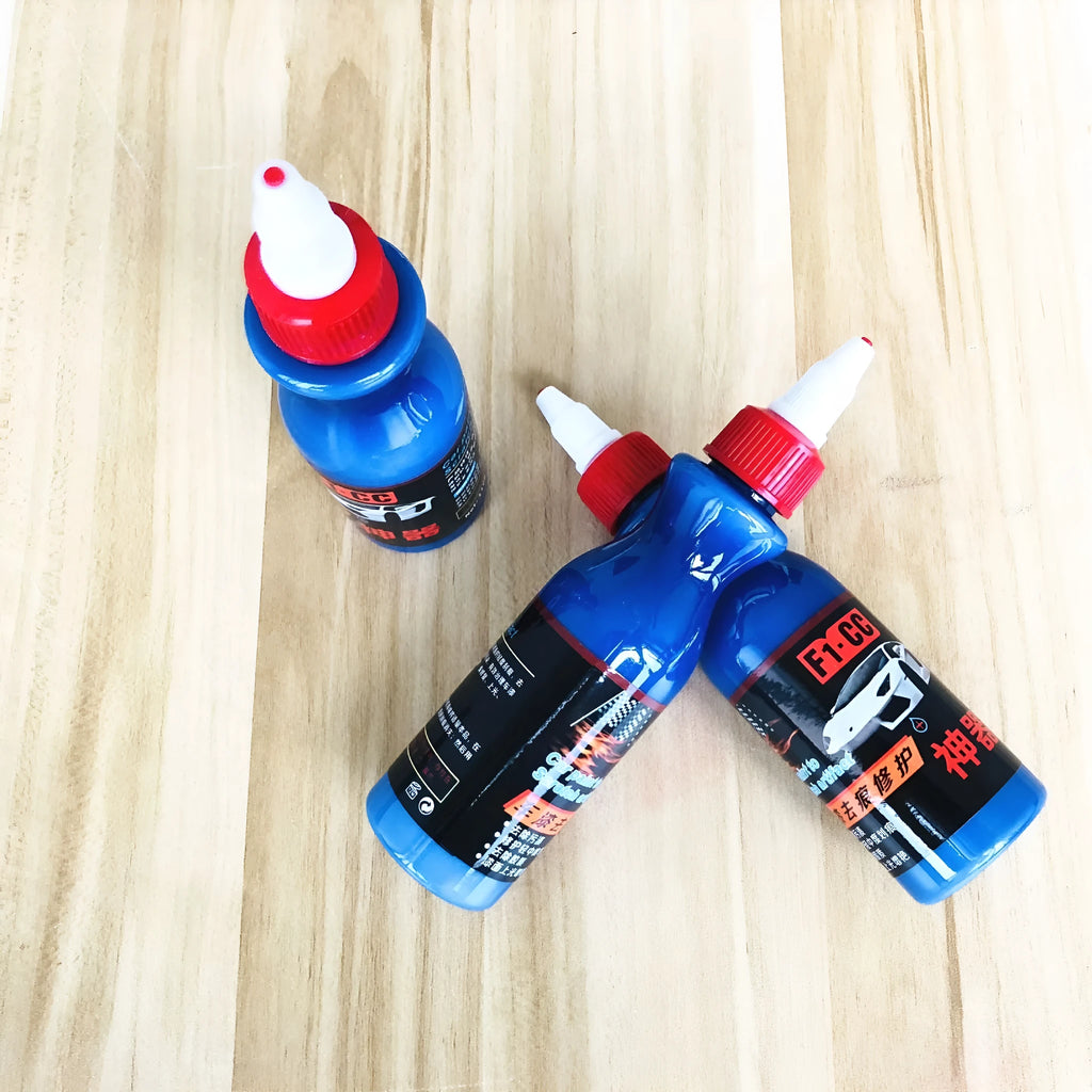 Blue car scratch repair cream bottle with applicator tool for automotive paint damage
