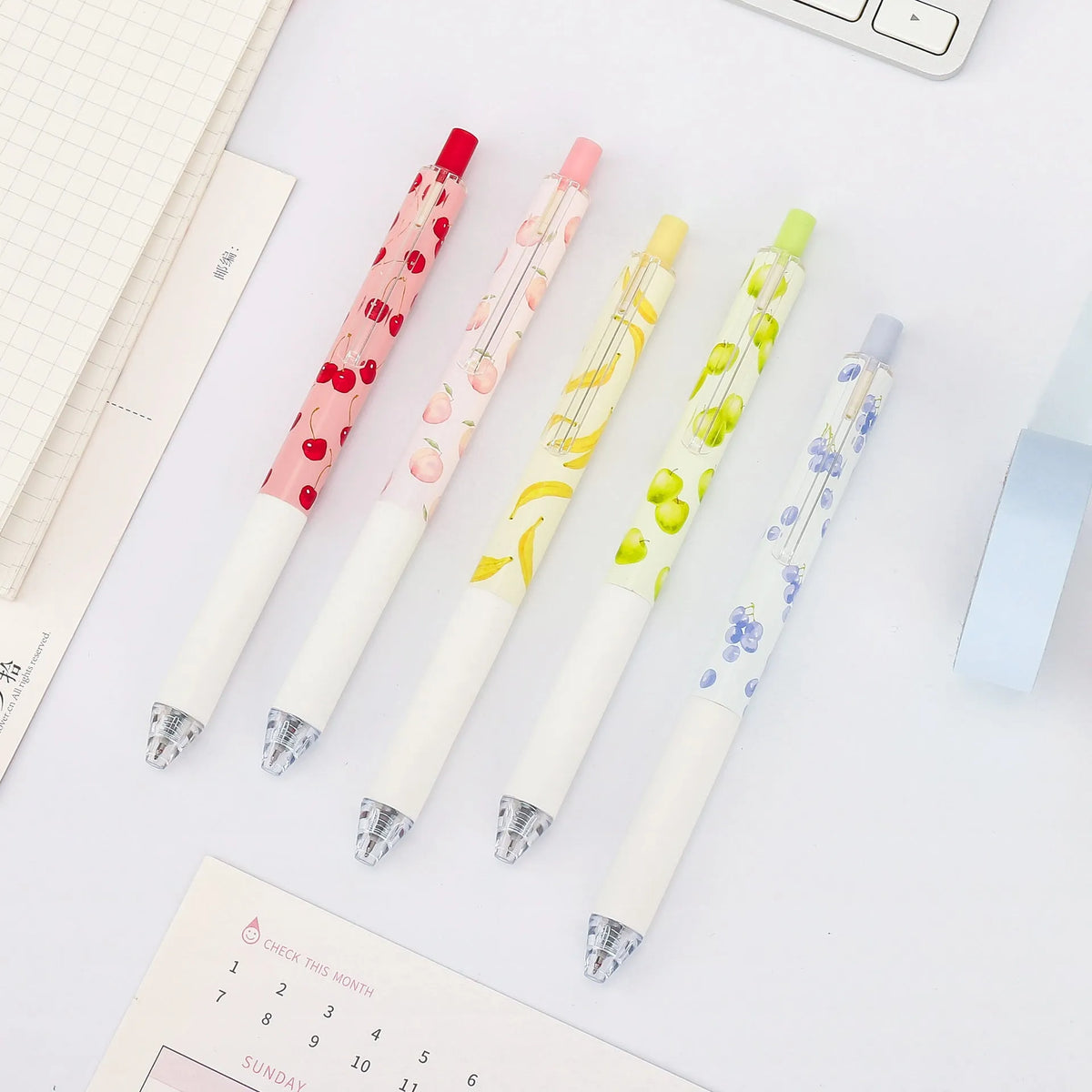 Three fruit-scented press-action pens with 0.5mm quick-drying black ink refills on writing paper