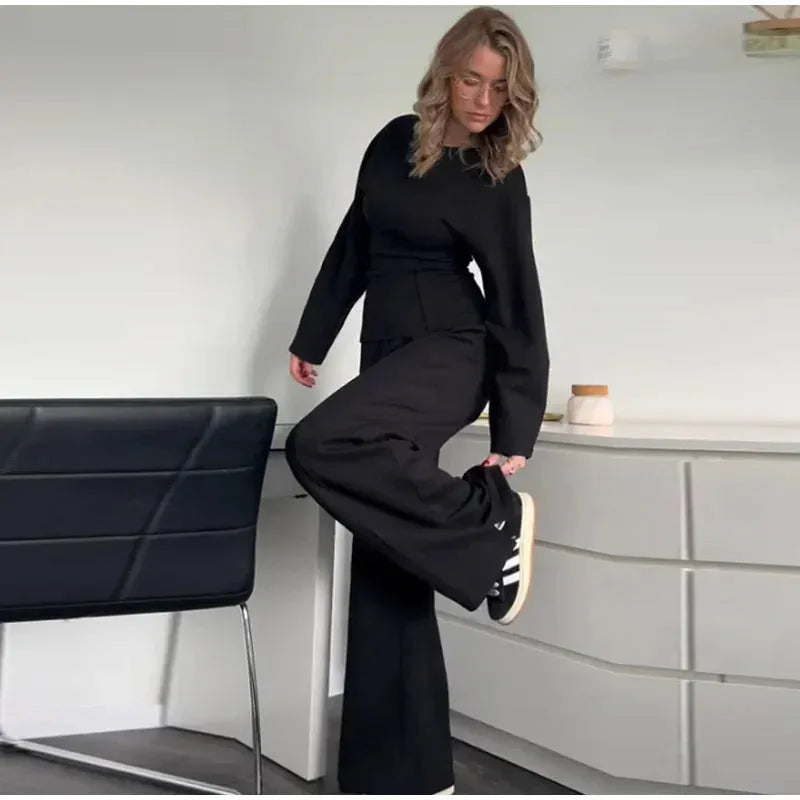 Women's black polar fleece trouser suit set with pleated long sleeve top and wide-leg pants on a hanger.