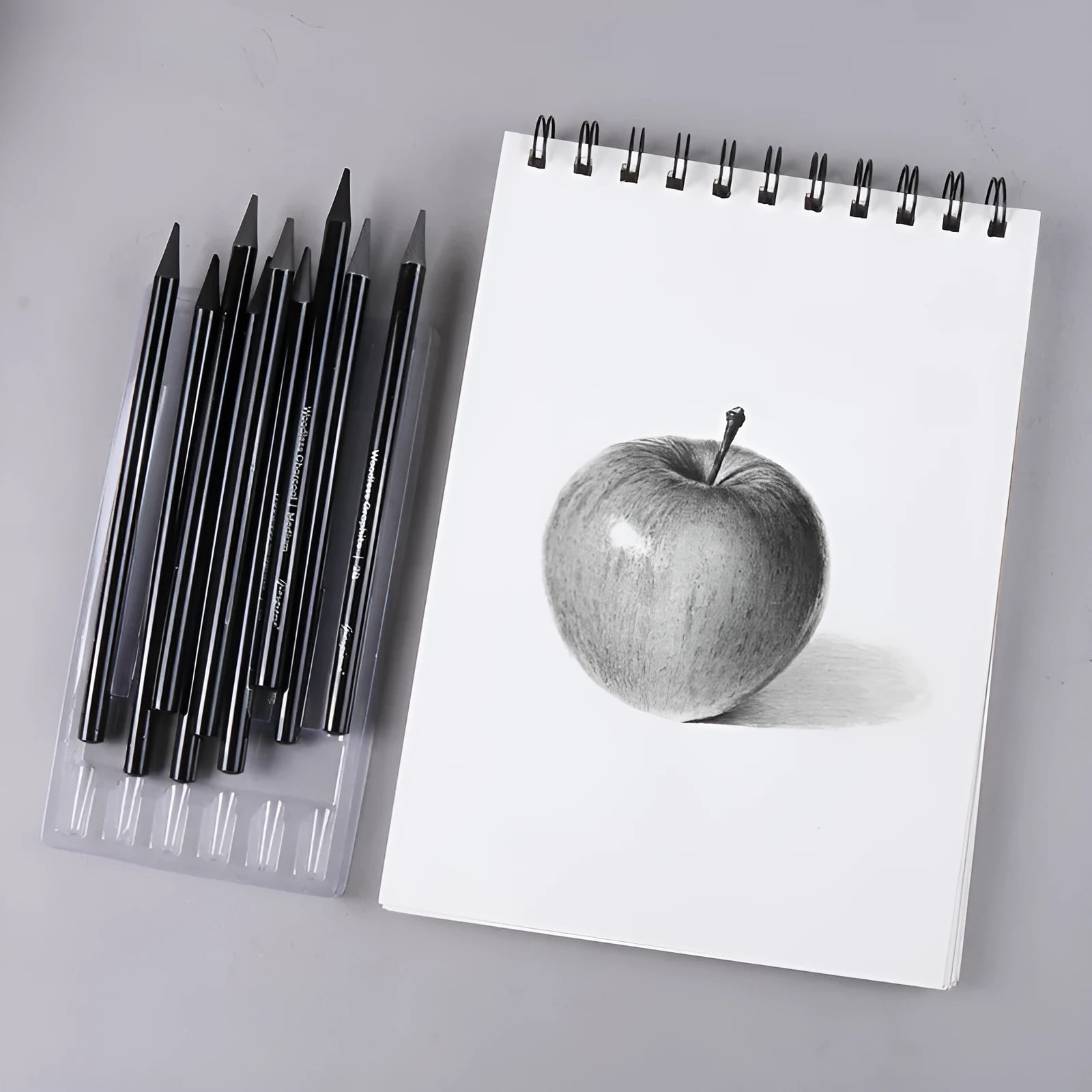 Graphite and carbonized pencil set showing six graphite pencils and three darker carbonized pencils on suction card packaging