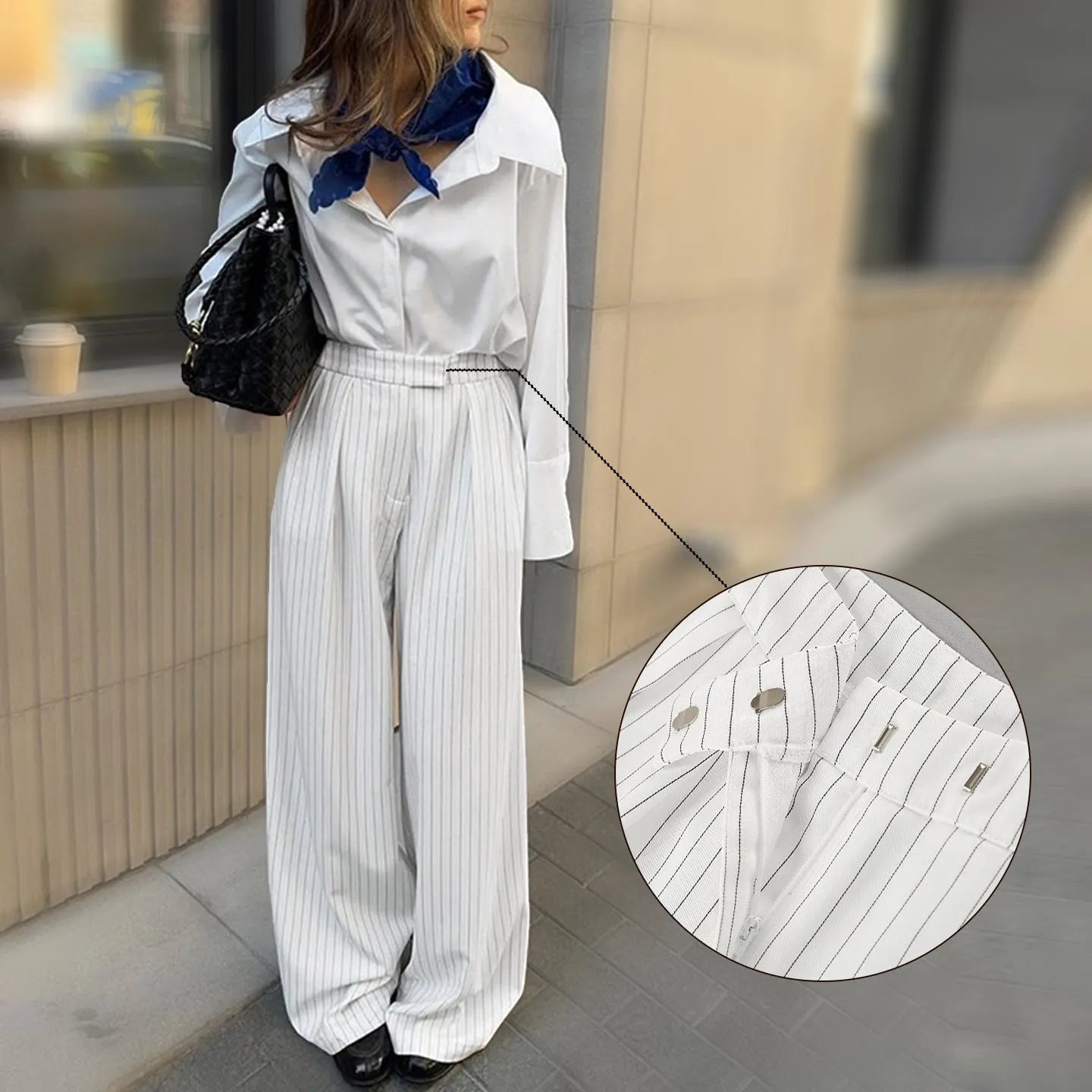 White striped wide-leg women's trousers with front zip fastening on hanger