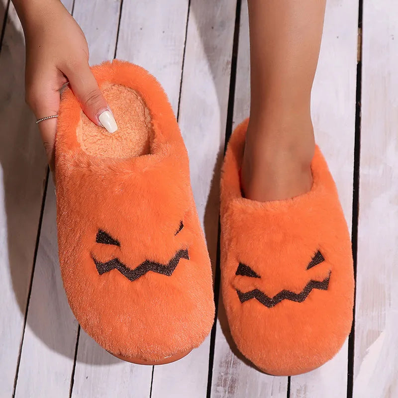 Orange Halloween pumpkin design plush slippers with coral velvet upper and non-slip sole.
